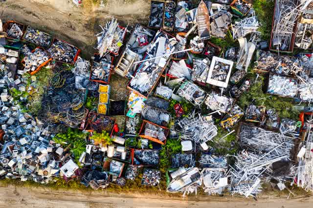 An aerial view of a real scrap yard, with materials sorted into bins ready for processing